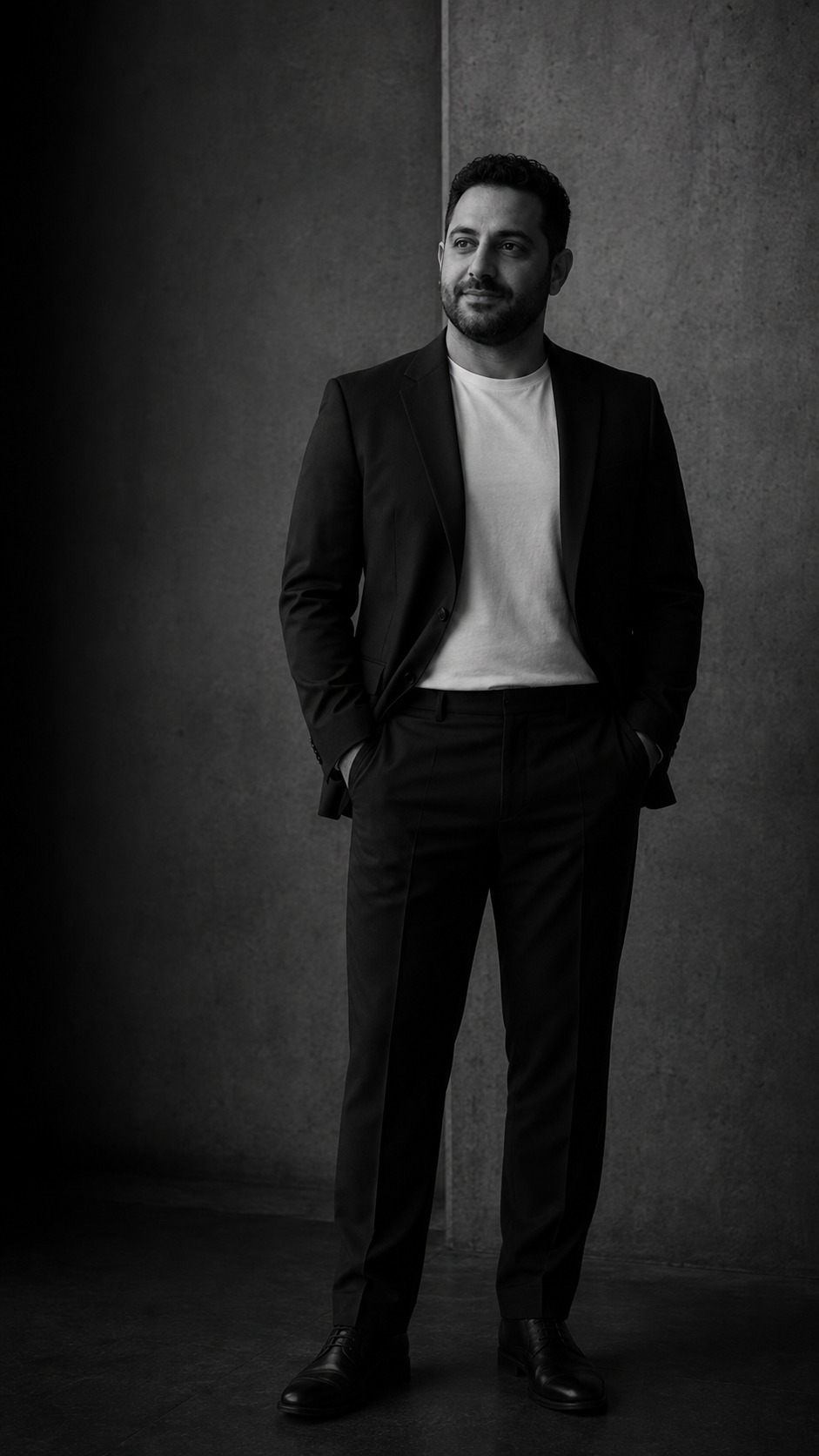 Portrait of David Delavega in a black suit within a London architectural interior